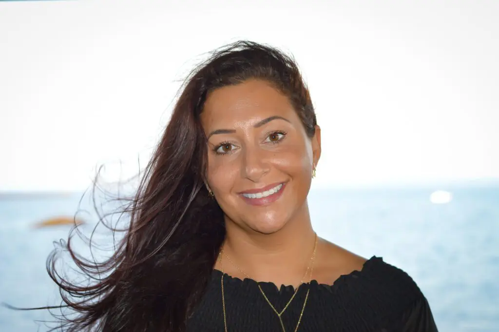 A woman with long hair is smiling for the camera.