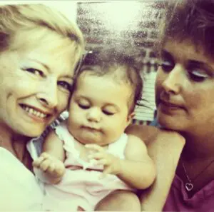 A woman and two women holding a baby.